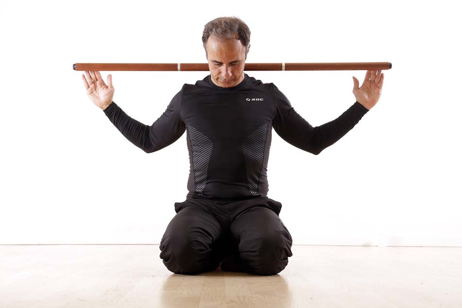 Marcus seated with stick across shoulders in Open Focus posture